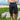 Man in cargo shorts with hands in pockets with surfboard 