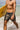 Man wearing reef camo board shorts holding yellow surf board coming out of the ocean