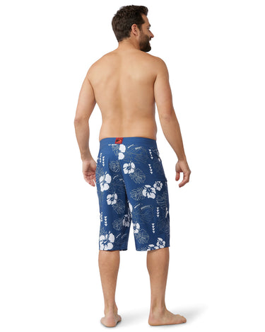 Man wearing the 24 inch blue hawaiian floral boardshorts from the back 