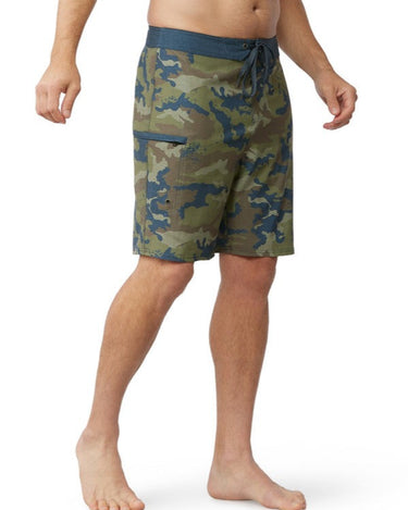 Man wearing reef camo boardshorts from the side exposing pocket with strong zipper