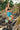 woman wearing emerald bay floral boardshorts holding fins 